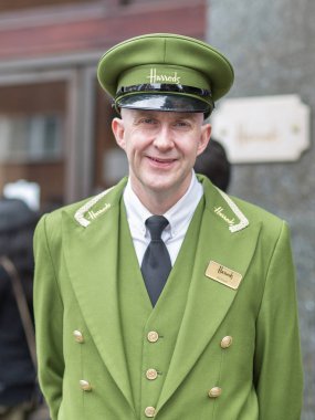 Londra, Birleşik Krallık - Haziran 2019: Sokak Fotoğrafçılığı: Londra 'da Harrods Mağaza Resepsiyonisti ve Yeşil Üniformalı ve Şapkalı Portresi