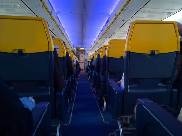 Aircraft Interiors and Cabin full of Passengers during Flight.