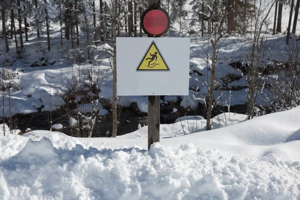 Warning Signal to Watch out for Falls on Ice and Snow in Background.