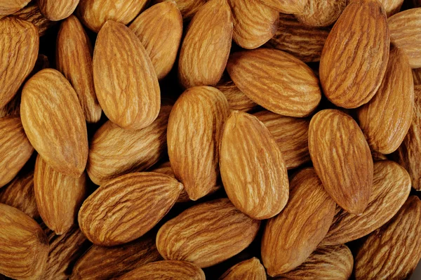 AlmondsPile of almonds close-up as background — ストック写真