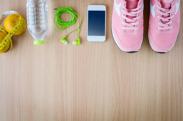 fitness concept with Exercise Equipment on wooden background.