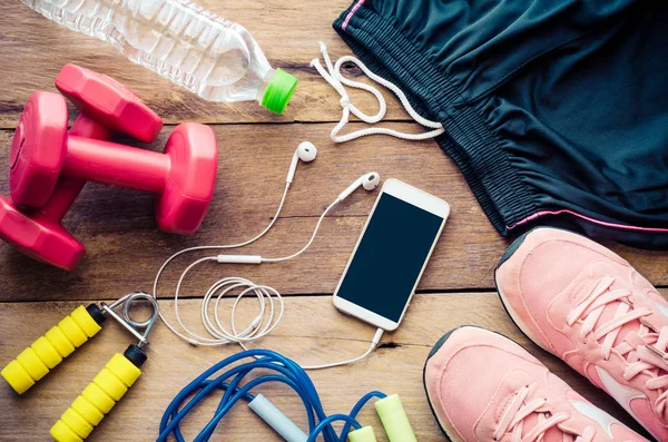 Fitness concept with Exercise Equipment on wooden background. — Stock Photo, Image