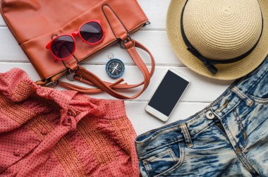 Kadınlar için giyim, beyaz bir ahşap zemin üzerinde yer.