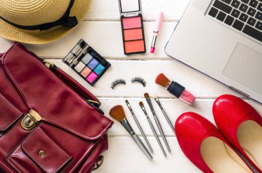 Beyaz ahşap zemin üzerinde kadınlar için giyim ve kozmetik