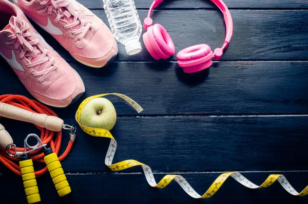 Fitness concept with Exercise Equipment on wooden background. — Stock Photo, Image