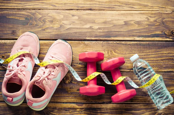 Fitness concept with Exercise Equipment on wooden background — Stock Photo, Image