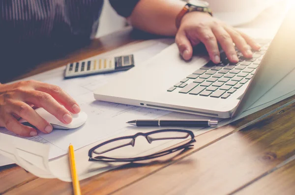 Geschäftsmann arbeitet an einem Tisch, auf dem ein funktionierendes Gerät platziert ist. — Stockfoto