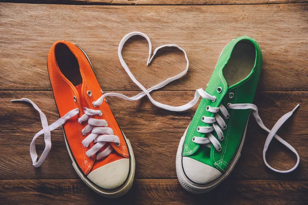 Orange and green sneakers with a rope made of heart style. -Vale — Stock Photo, Image