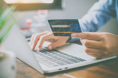 Kredi kartları ve cep telefonu tutan kadın şimdi internet üzerinden kredi kartı ile ödeyerek alışveriş vardır.