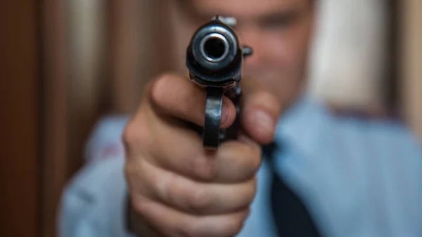 A hired assassin, a terrorist or a policeman in a black mask with a black combat gun — Stock Photo, Image