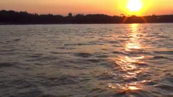 Coucher de soleil, rivage, à bord du bateau. le mouvement à travers l'eau, tirant sur le rivage — Video