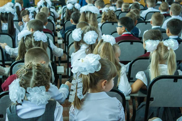 Muitas crianças sentam-se vestidas na sala de reuniões em um concerto dedicado ao Dia do Conhecimento no dia 1 de setembro. — Fotografia de Stock
