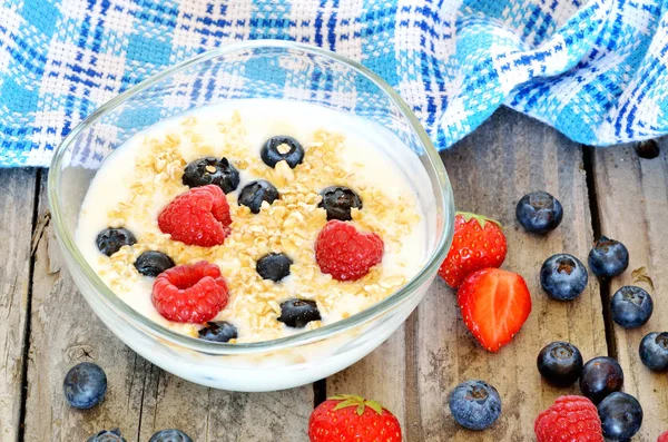 Weißer Joghurt in einer Schüssel mit Haferflocken, Blaubeeren, Himbeeren und Erdbeeren — Stockfoto