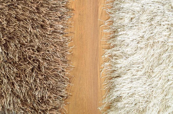 Brown and white hairy carpets divide in half and floating floor