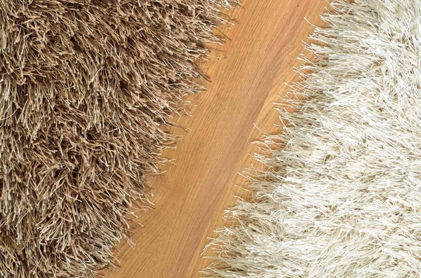 Brown and white hairy carpets divide in half and floating floor — Stock Photo, Image