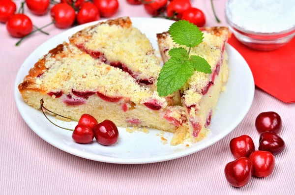 Czech baked souffle cake with cherries and mint leaves. — Stock Photo, Image