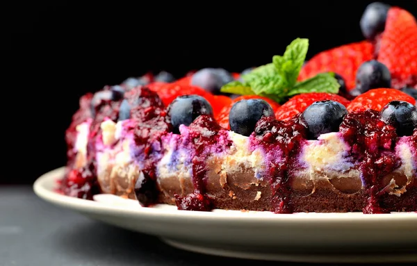 Torte mit frischen Erdbeeren, Blaubeeren und Kirschmarmelade. Dunkler Hintergrund. Geringe Schärfentiefe — Stockfoto