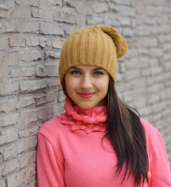 Portrait fashion cool girl in colorful clothes over wooden background wearing a  hat and pink  sweater — Stockfoto