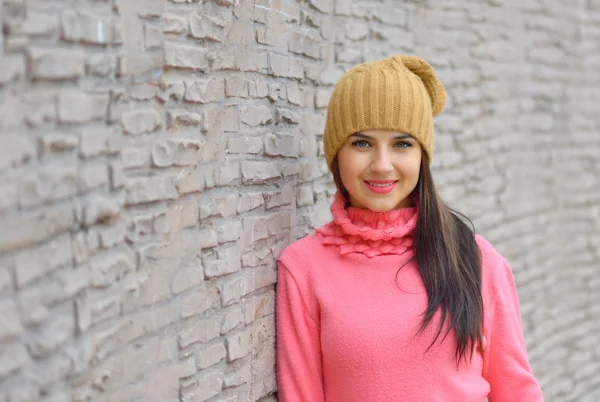 Portrait fashion cool girl in colorful clothes over wooden background wearing a  hat and pink  sweater — Stockfoto