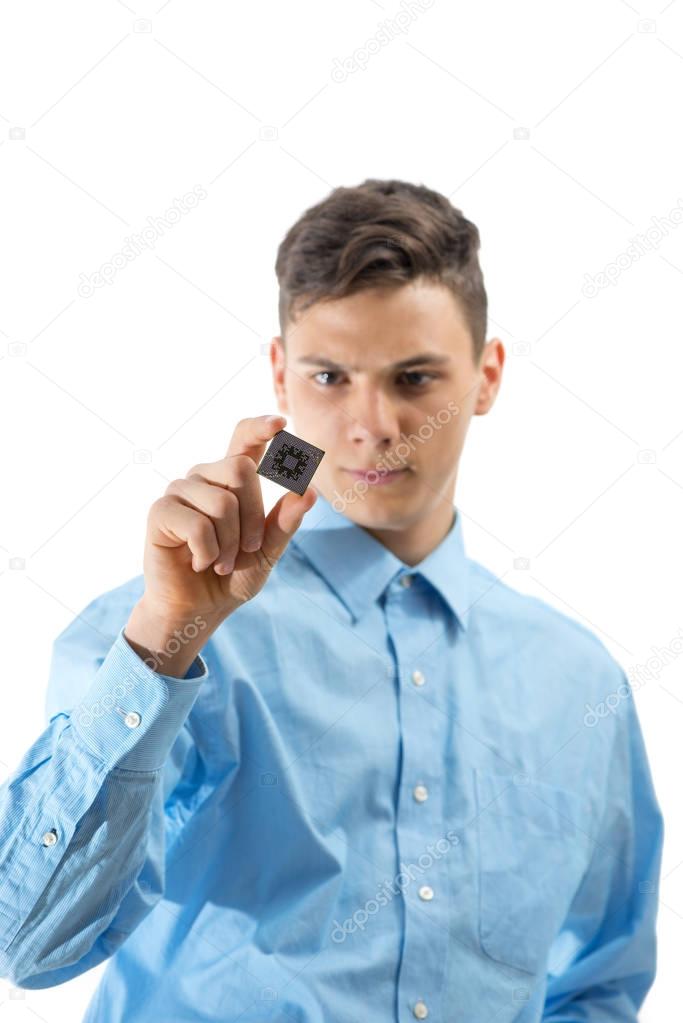 Teenager looking at a micro chip isolated on white background