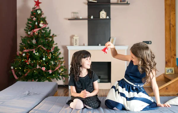 Two  sisters amusing themselves with a bell — Stock Photo, Image