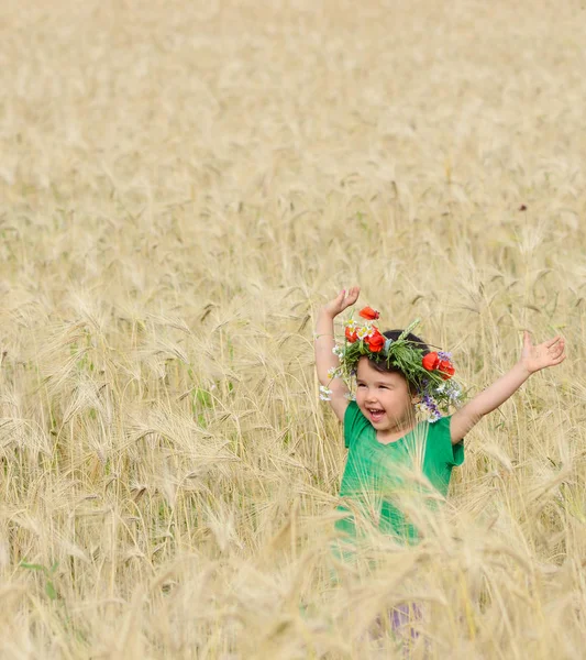 Cute happy baby playing on wheat field — Stock Photo, Image