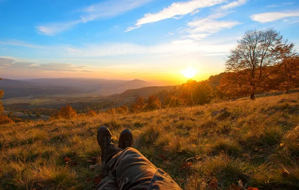 Photographer resting and having beautiful view of mountains at sunset — Stock Photo, Image