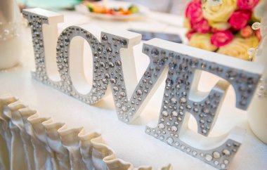 Dekoratif harf kelime şekillendirme ahşap zemin üzerinde kır çiçekleri ile seviyorum.