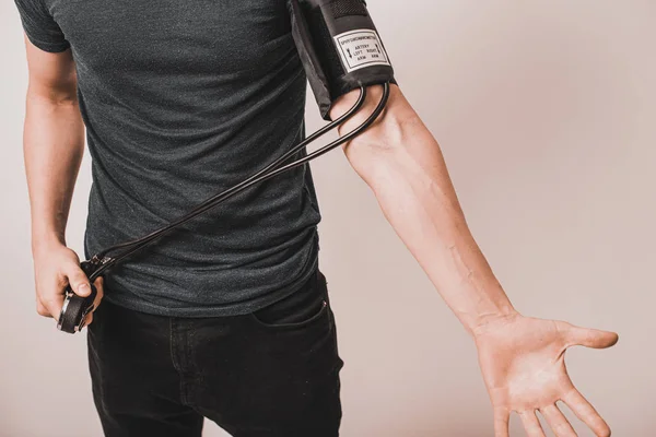 Young Man Taking Blood Pressure — Stock Photo, Image