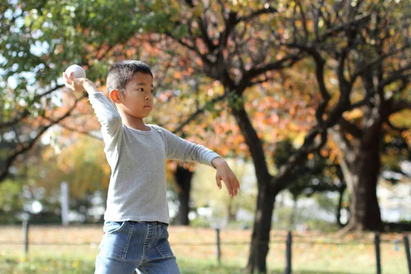 Japanese boy playing catch (first grade at elementary school)