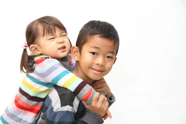 Japanese boy carrying his sister on his back (7 years old boy and 2 years old girl) — Stock Photo, Image