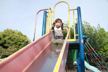 Japanese girl on the slide (2 years old) clipart