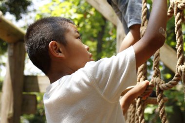 Japon çocuk ropewalking ile oynarken (ikinci sınıf ilköğretim okulunda)