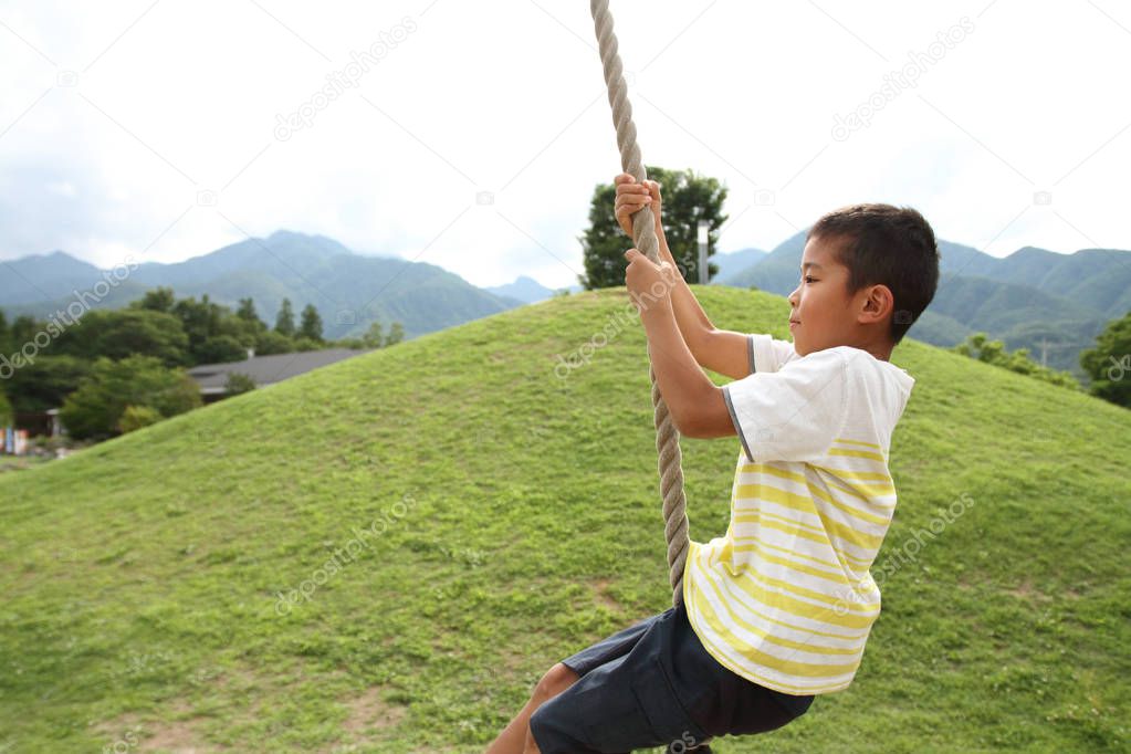 Japanese boy playing with flying fox (second grade at elementary school)