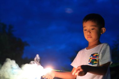 Japon çocuk el havai fişek yapıyor (ikinci sınıf ilköğretim okulunda)