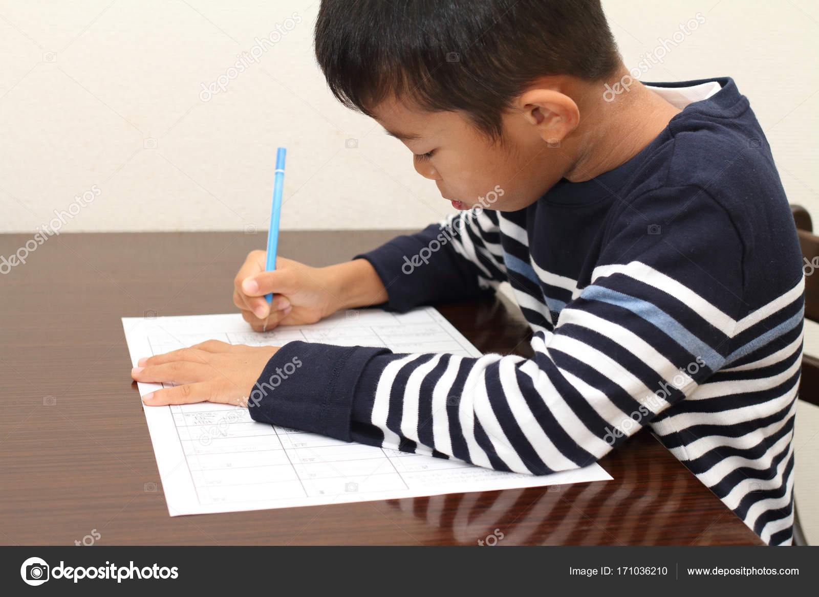 Japanese boy doing homework (second grade at elementary school) Stock Photo by ©ziggy_mars 171036210