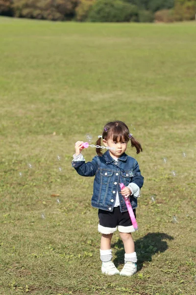 日本の女の子 (3 歳) がバブルで遊んでください。 — ストック写真
