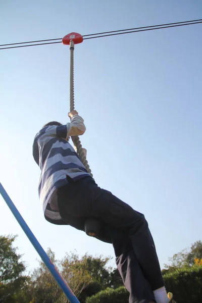 Japanese boy playing with flying fox (second grade at elementary school) — Stock Photo, Image