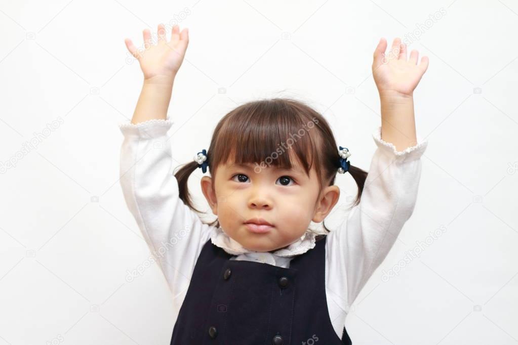 Japanese girl raising her hand in formal wear (2 years old)
