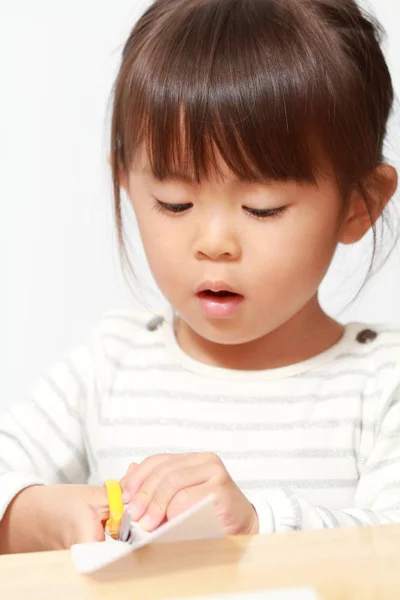 Menina japonesa cortando papel com tesoura (3 anos de idade ) — Fotografia de Stock