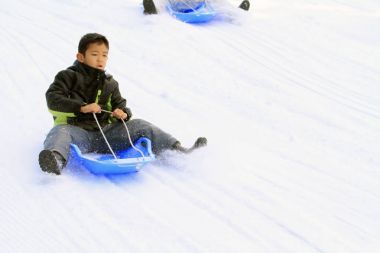 Japon çocuk üzerinde kızak (ikinci sınıf ilköğretim okulunda)