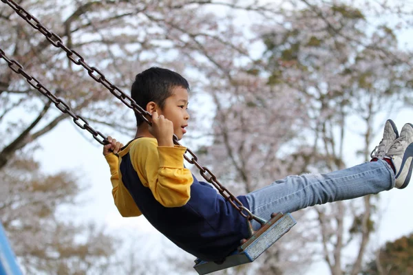 Japanese boy on the swing (third grade at elementary school) — Stock Photo, Image