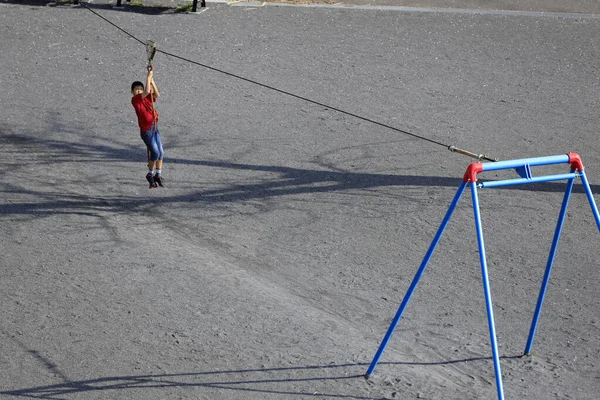 Japanese boy playing with flying fox (fourth grade at elementary school)