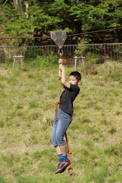 Japanese boy playing with flying fox (fourth grade at elementary school)