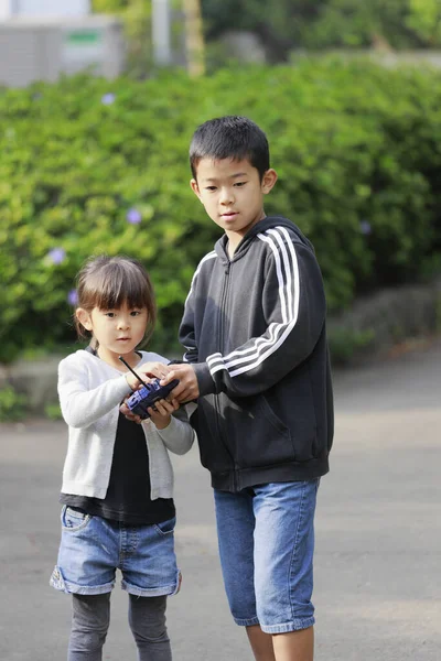 Japanese brother and sister operationg radio control (10 years old boy and 5 years old girl)