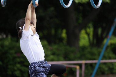 Japon kız maymun parmaklıklarıyla oynuyor (5 yaşında))