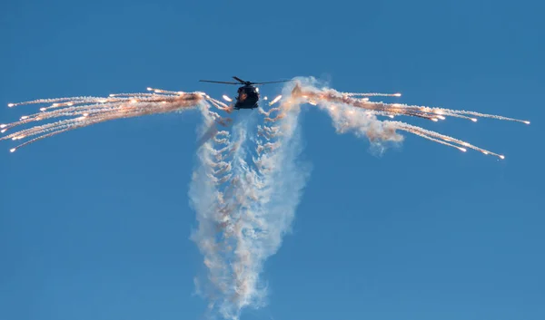 Finnish Army NH-90 helicopter shooting out flares Stock Photo