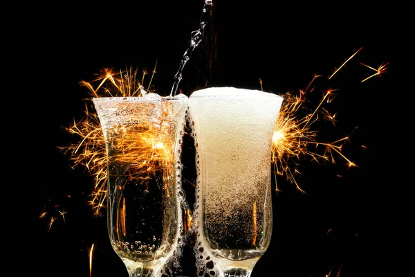 Glass of champagne with splash, isolated on black background