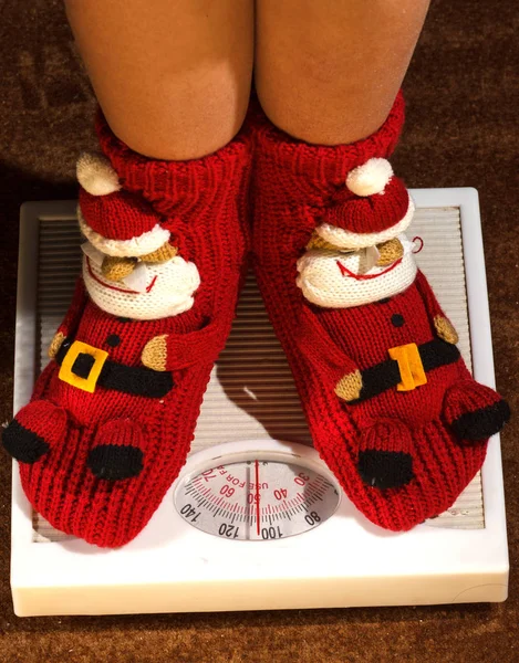 Girl standing on floor vysah in Christmas socks — Stock Photo, Image