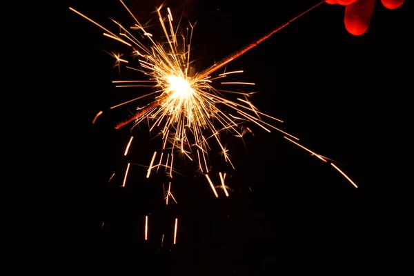 Bright festive Christmas sparkler in hand toning — Stock Photo, Image